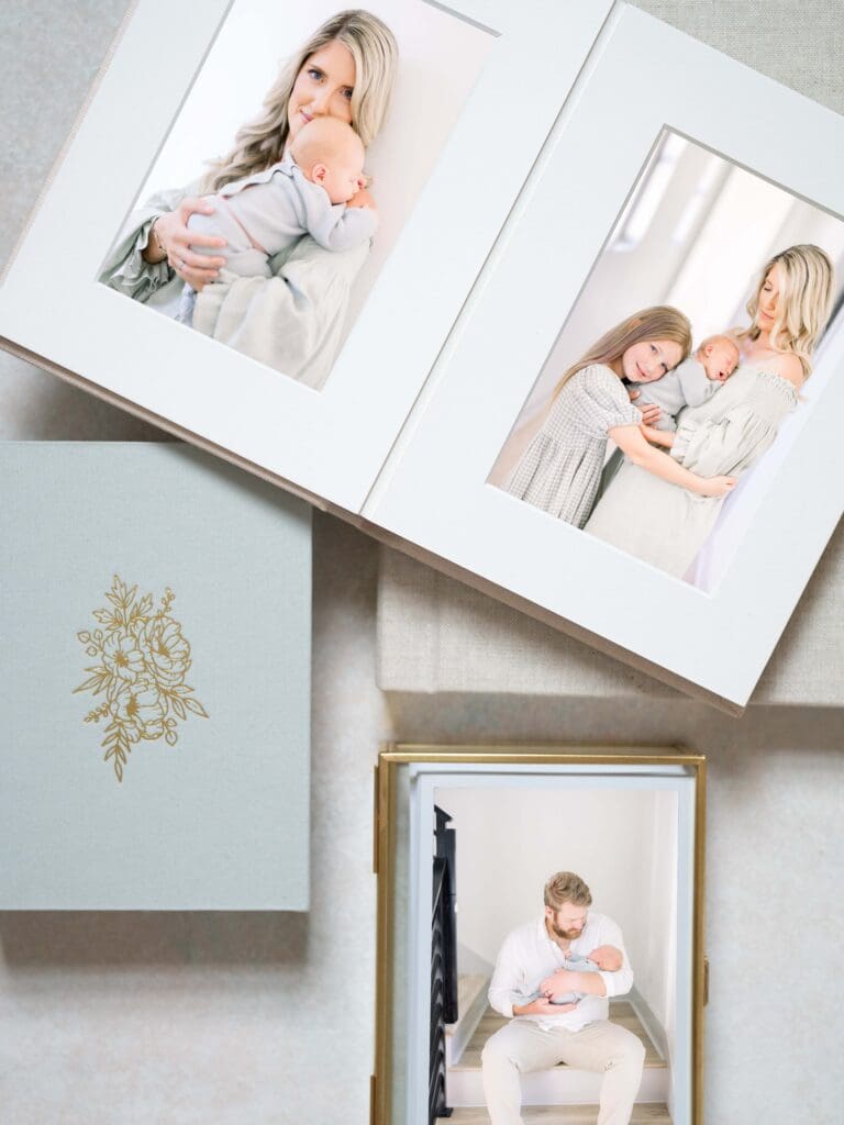 Mockups of newborn photographs in matted print album and prints in a glass box.
