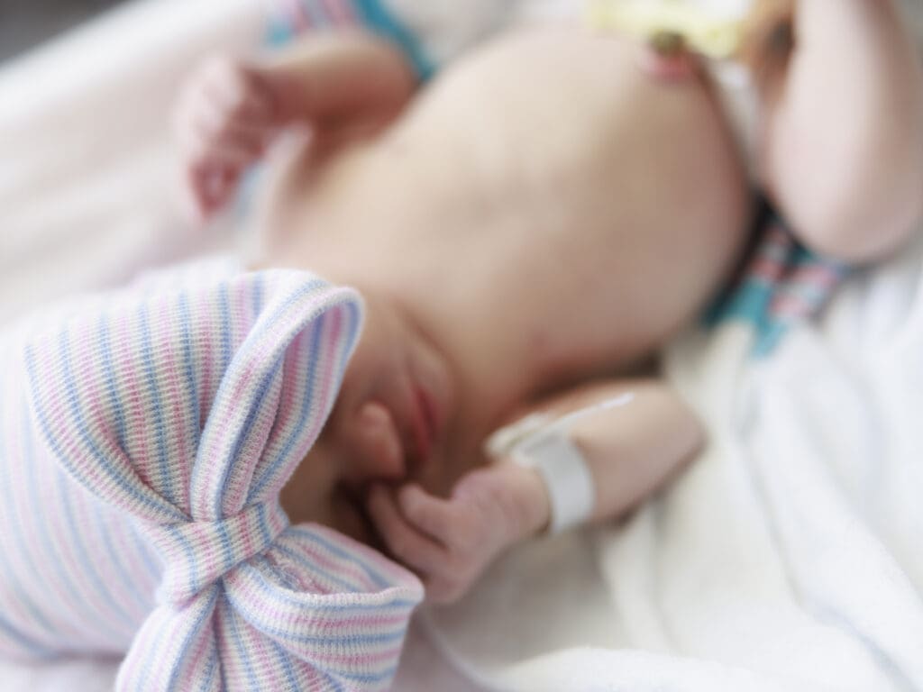 Baby with hospital band and in hospital hat that does c-section in Tampa
