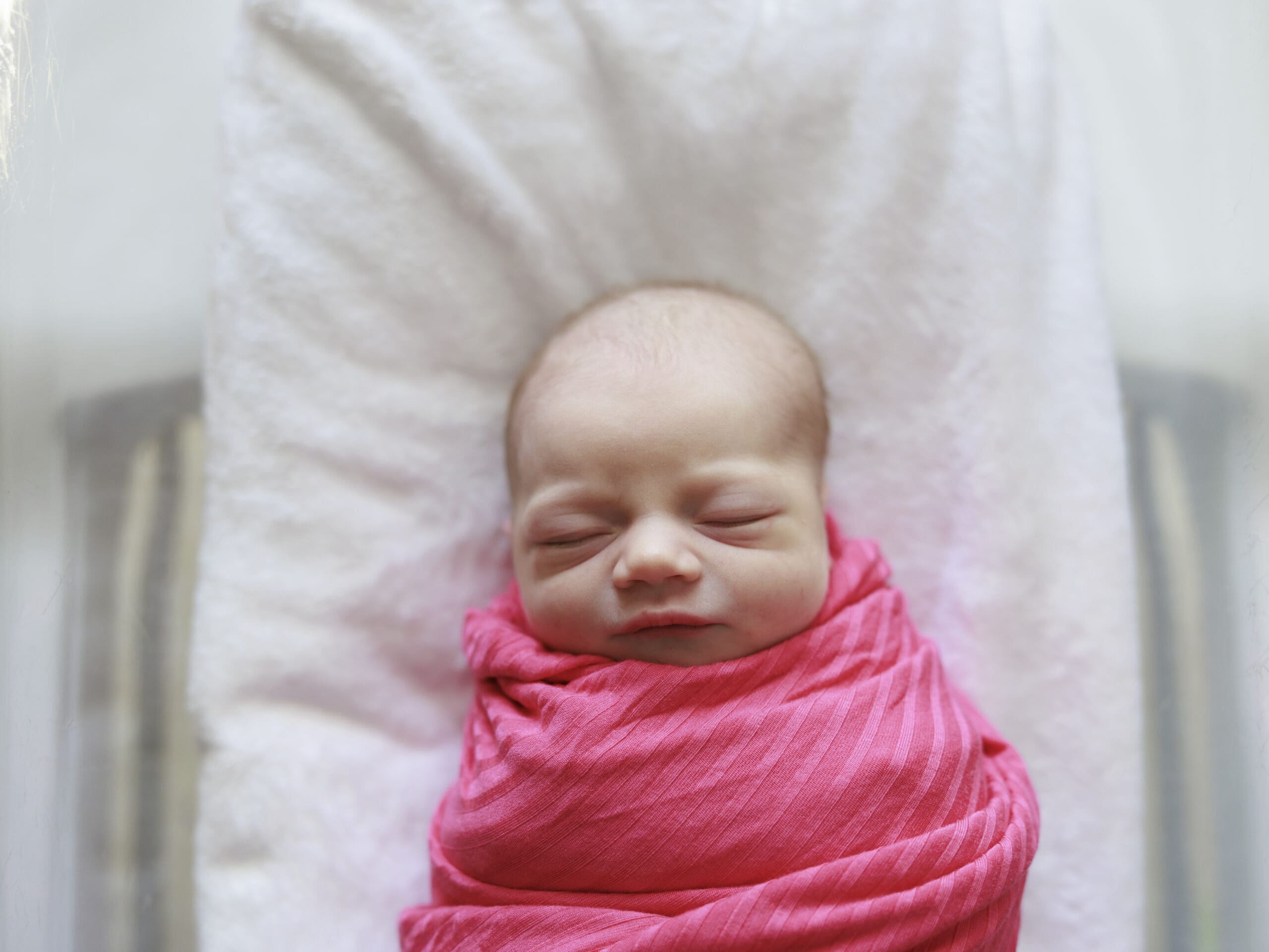 Newborn baby in pink swaddle taken during a Fresh 48 photo session in Tampa.
