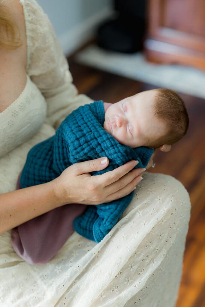 Mother demonstrating elevated side-lying position for bottle feeding newborn baby tips in Tampa