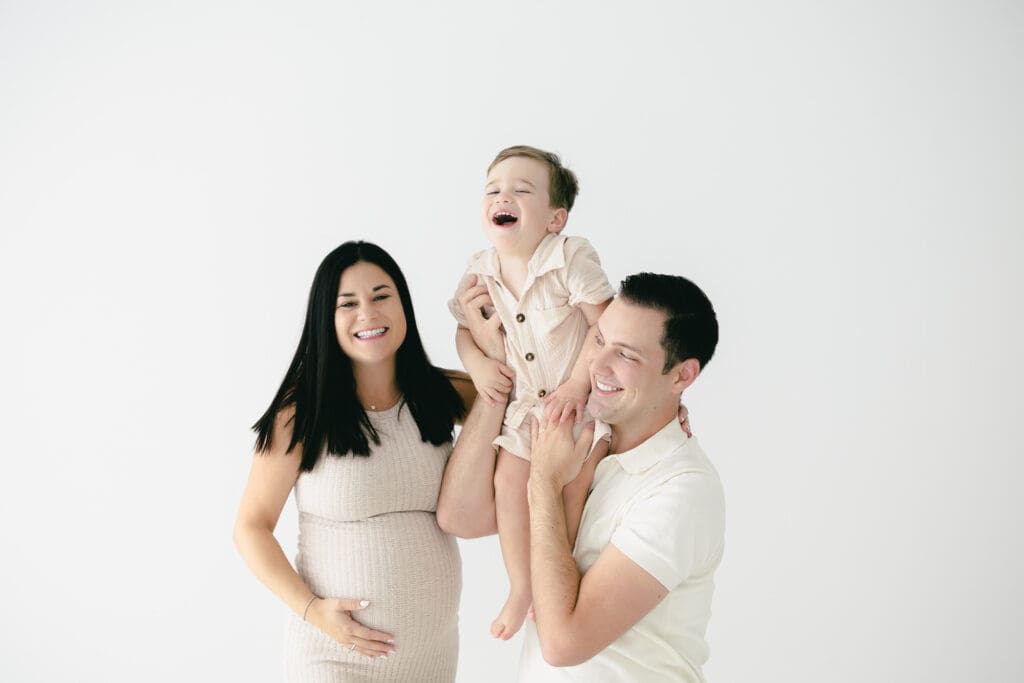 Candid, joyful moment from a lifestyle family maternity session in Tampa.