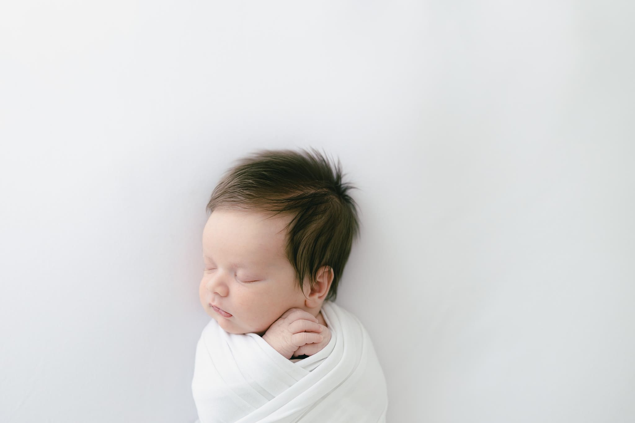 Newborn baby showing calm readiness cues during Tampa newborn session